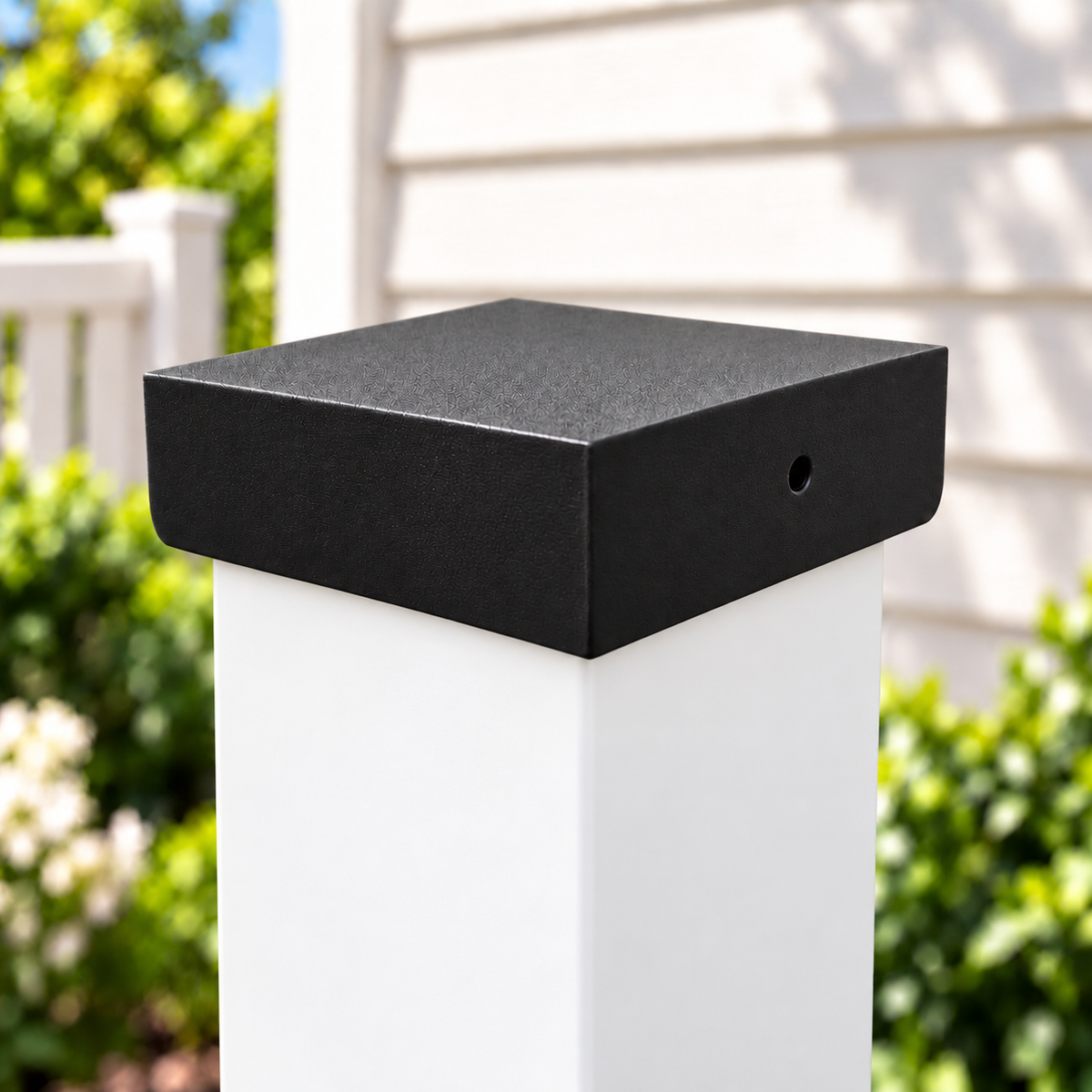 Black plain post cap installed on a post, close-up view