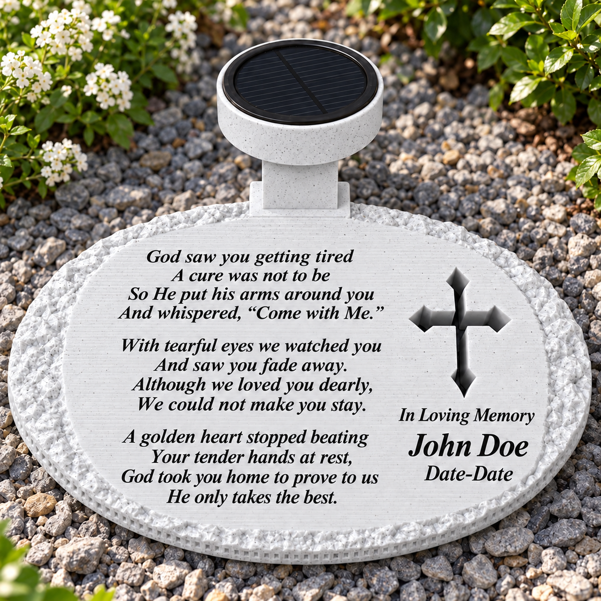 White rough oval solar memorial with cross and God Saw You Getting Tired poem in a garden