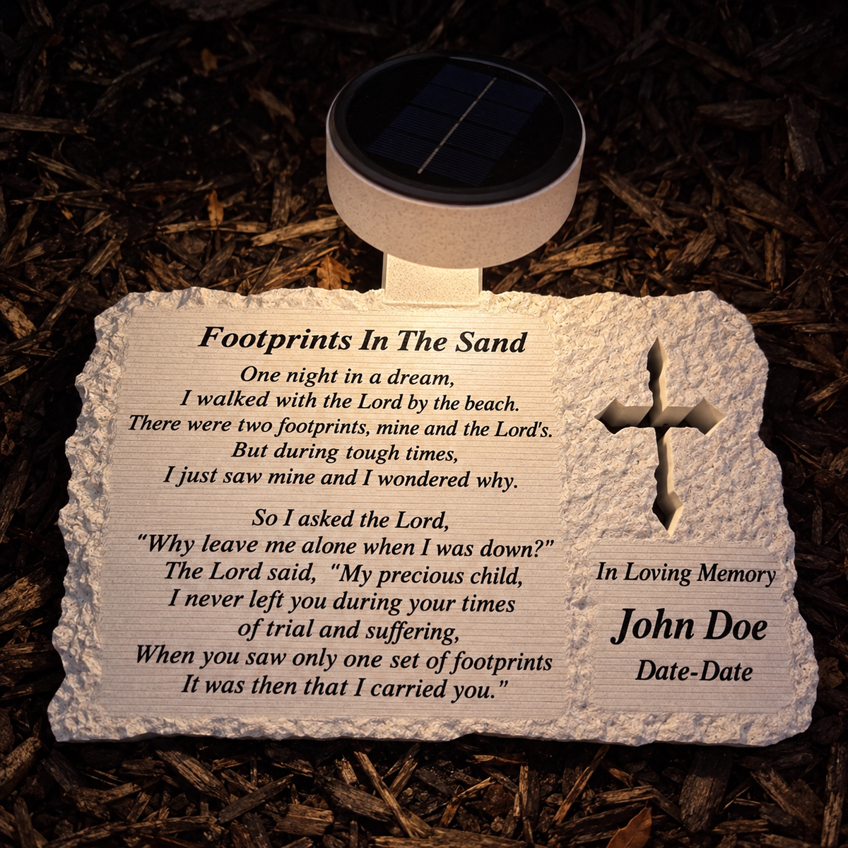 Evening illustration of the solar LED illuminating a cross memorial with Footprints In The Sand poem and John Doe example inscription