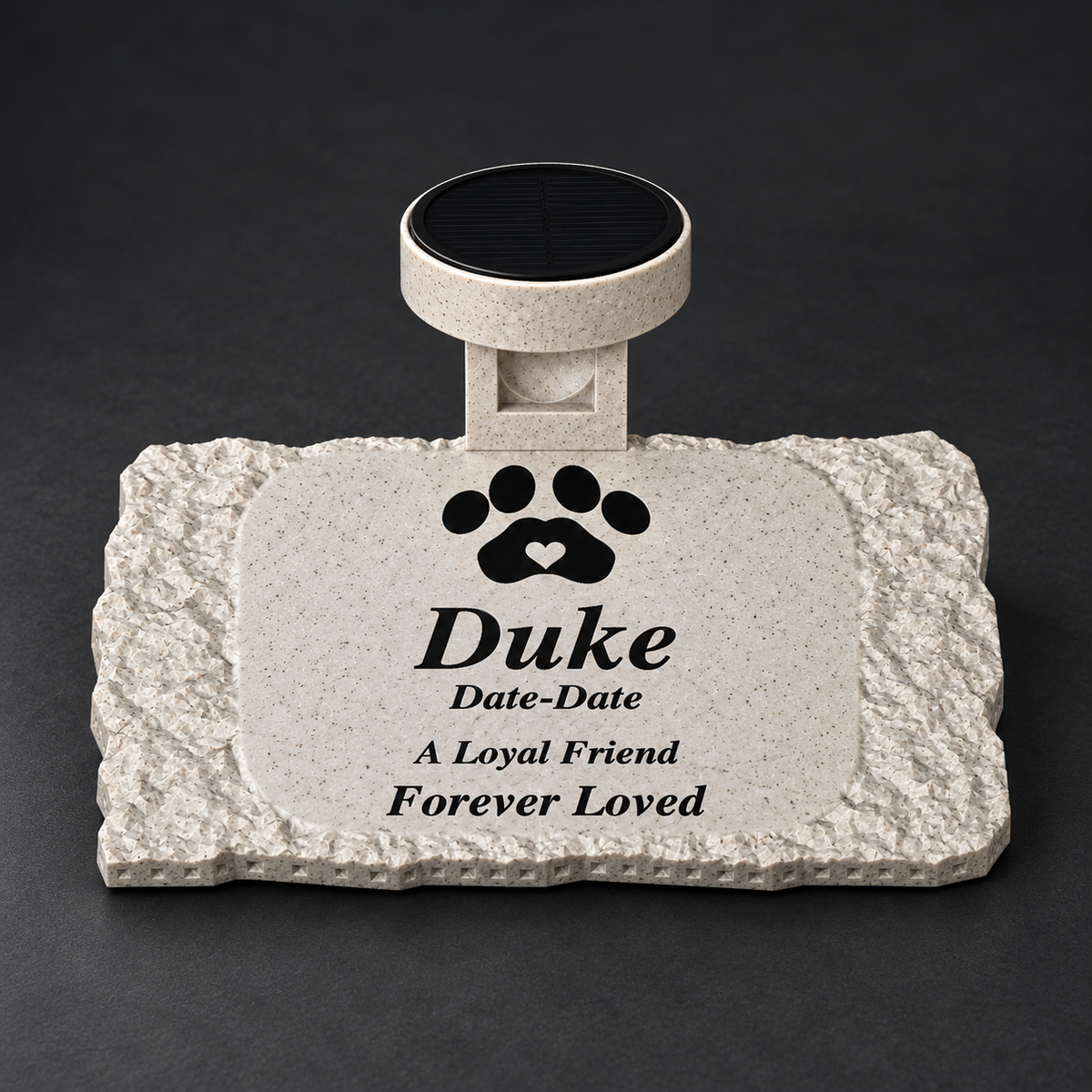 Rough rectangular marble-look pet memorial with black Duke inscription, black paw with marble-white heart, and matching solar light